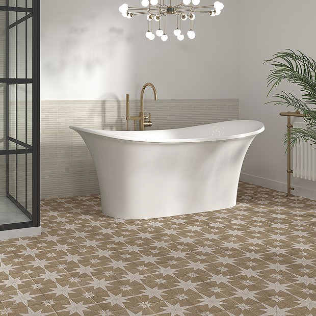 Cream and white tiles under a large bath with a chandelier