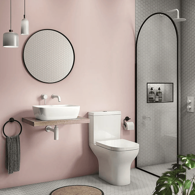 Pink bathroom with black arched shower screen