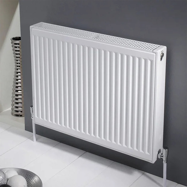 White radiator on grey wall