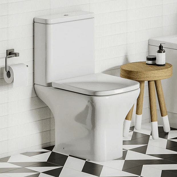 White modern toilet on black and white tiles
