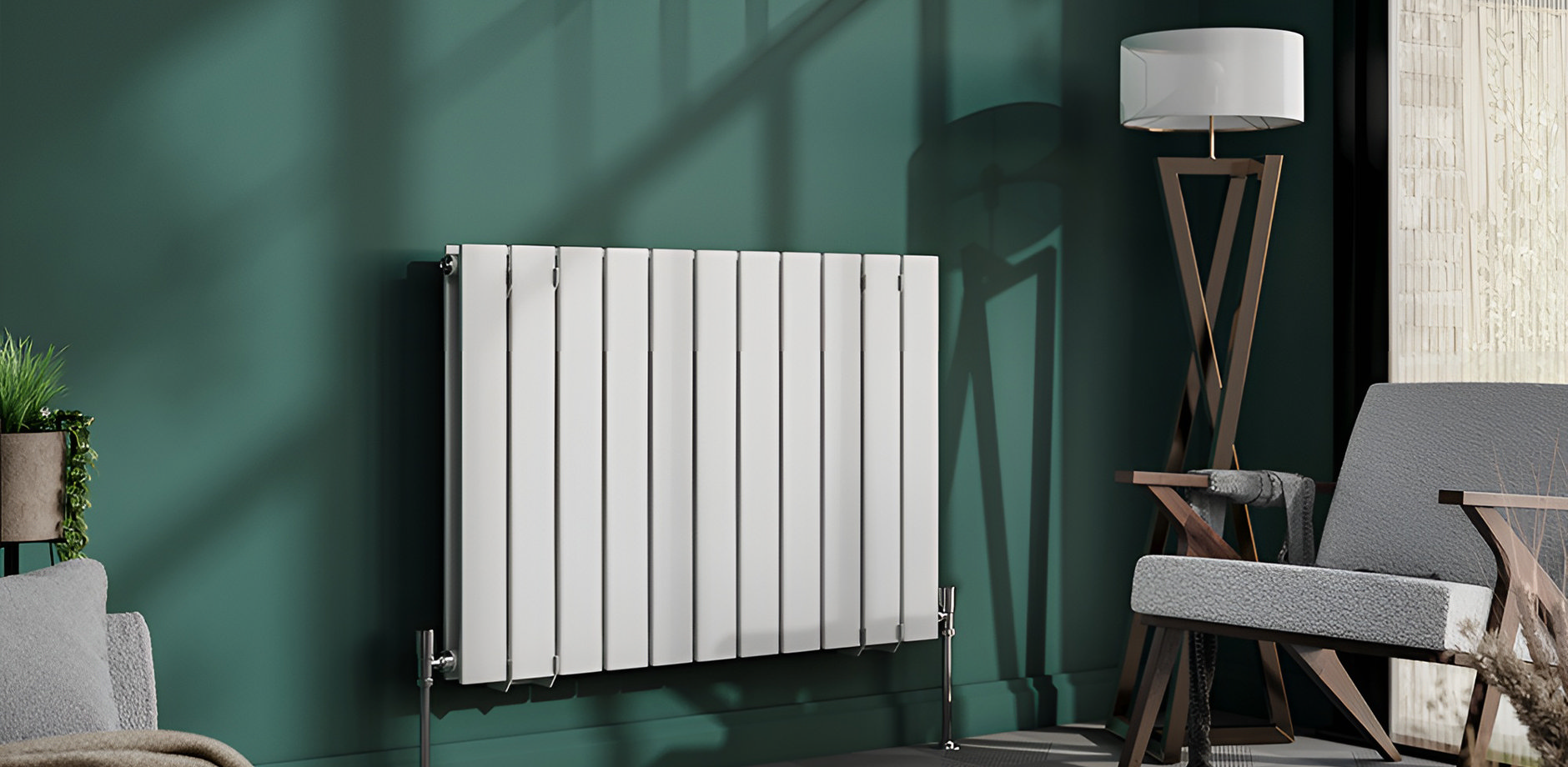 White panel radiator mounted on dark green wall and floor lamp