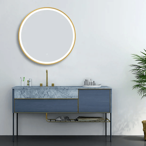 Brass round mirror over blue vanity against white wall