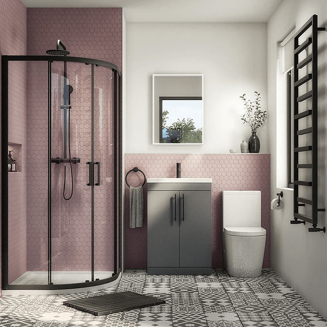 Small bathroom with pink tiles and black accents