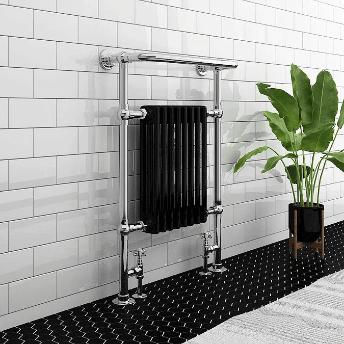 Black and chrome traditional towel rail against white brick wall