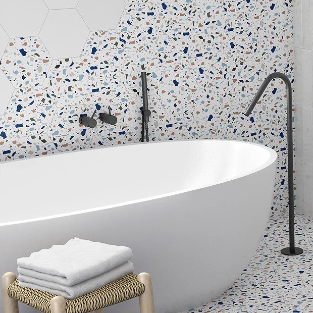 Terrazzo tiles and bath with black taps