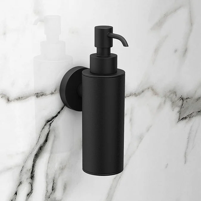 Matt black wall mounted soap dispenser on marble wall