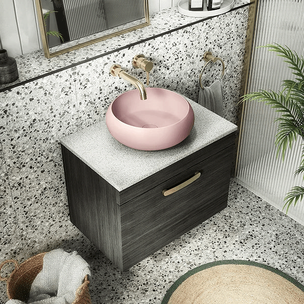 Pink countertop basin with brass tap