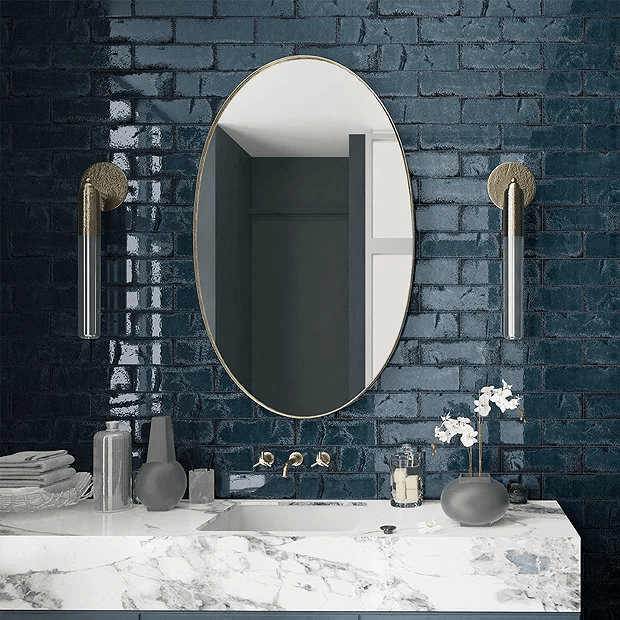 Dark blue rustic tiles with large mirror and marble basin