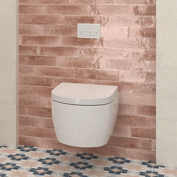 Pink tiles behind wall mount toilet