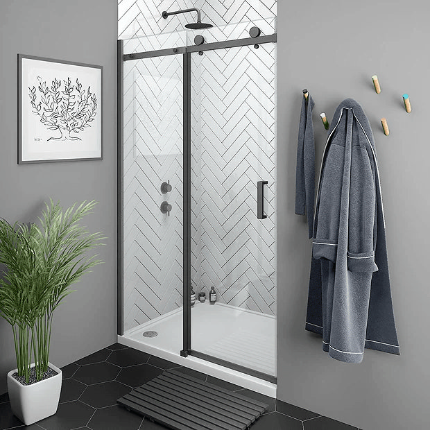 Black sliding shower door in grey bathroom