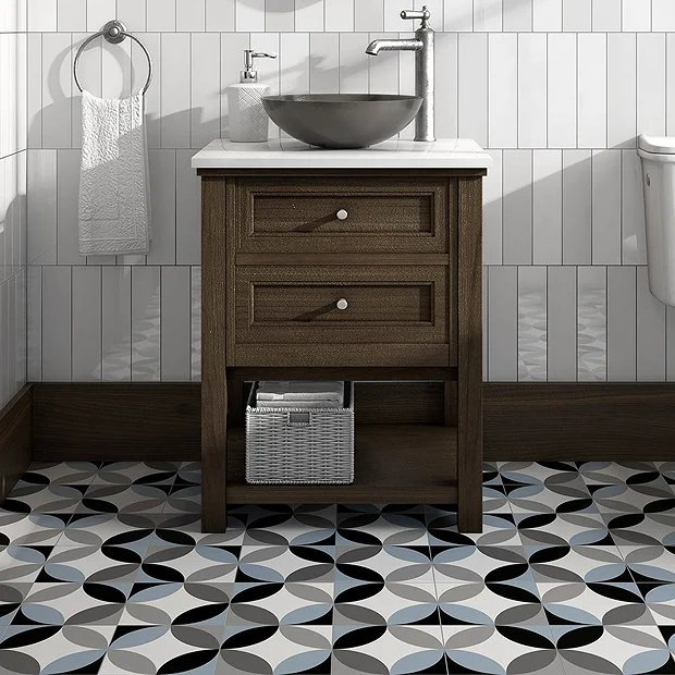 Blue and black tiles in bathroom with wooden vanity unit