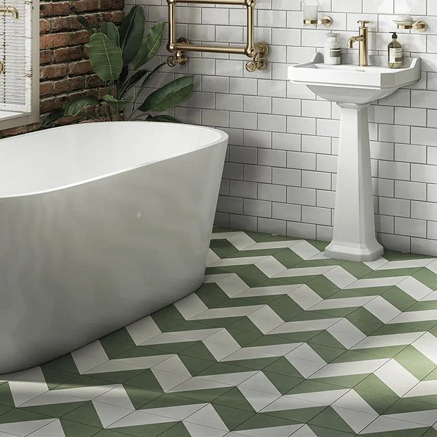 Green and white tiles in bathroom with brick wall