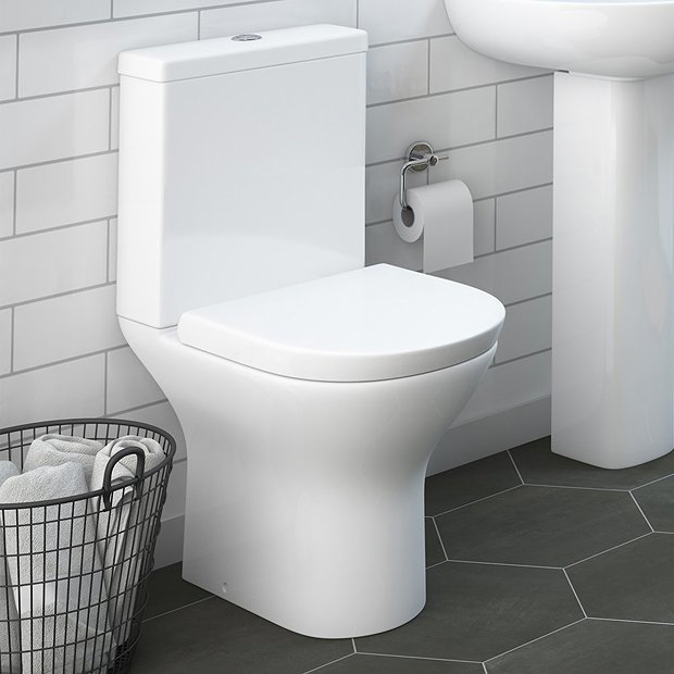 White toilet against white tiles