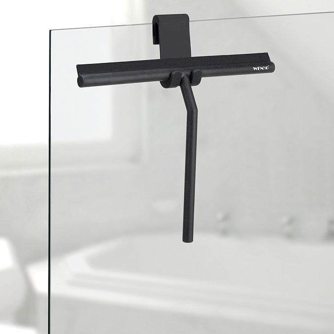 Black squeegee hung on shower screen