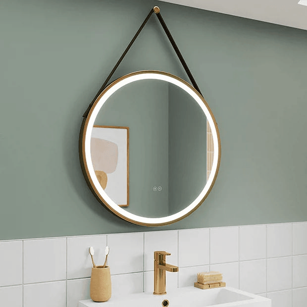 Round hanging light up mirror on green wall