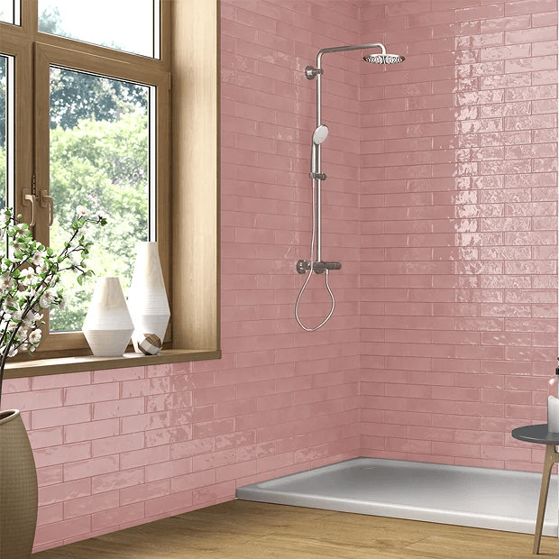 Pink brick effect wall tiles which chrome shower and large widnow