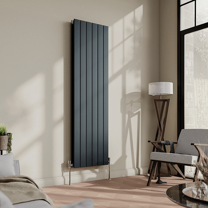 Grey vertical radiator mounted on cream wall