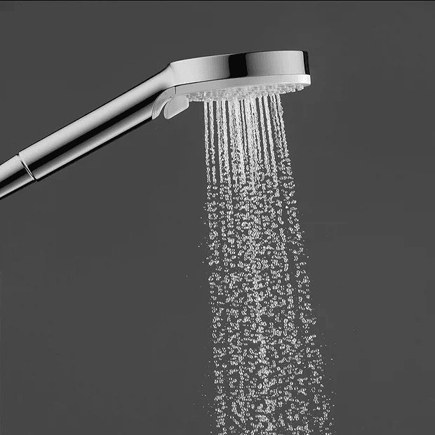 Chrome shower head in grey room
