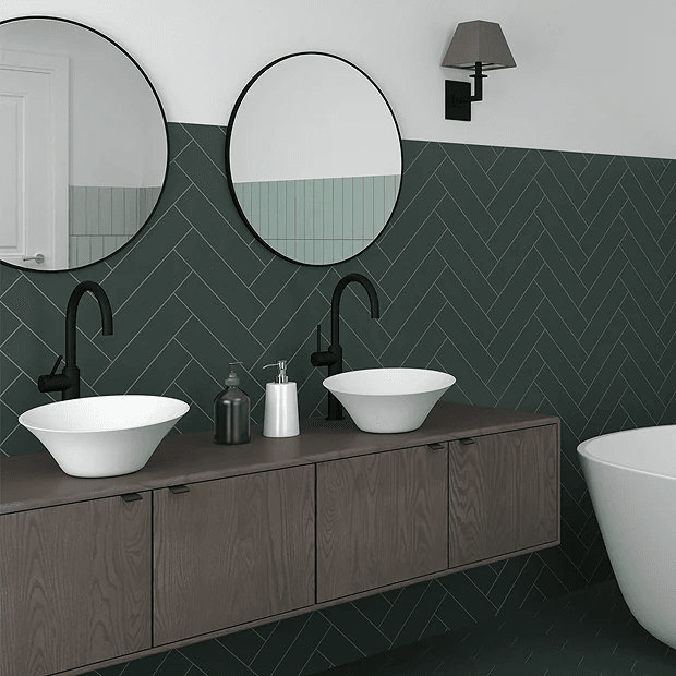 Dark green wall tiles with wooden wall mounted unit and countertop basins