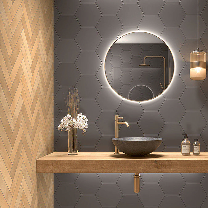 Light orange wall tiles with counter top basin and illuminated mirrow