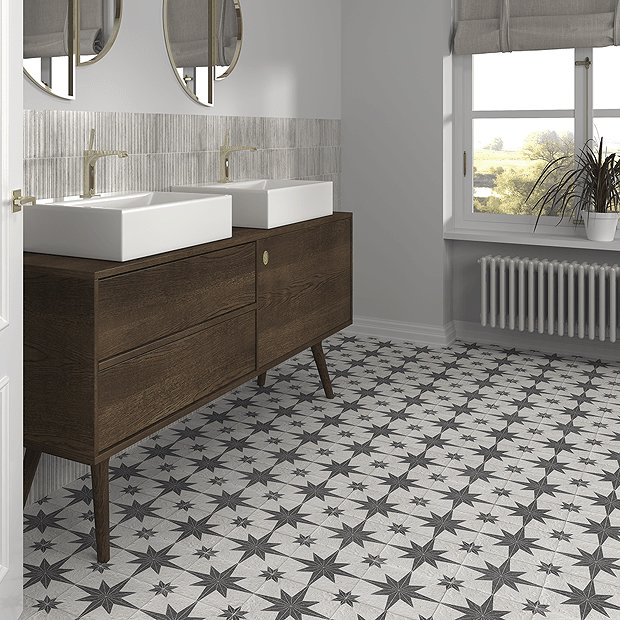 Black and white bathroom floor tiles and wooden vanity unit