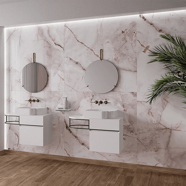 Pink marble tiles behind wall mounted vanity units