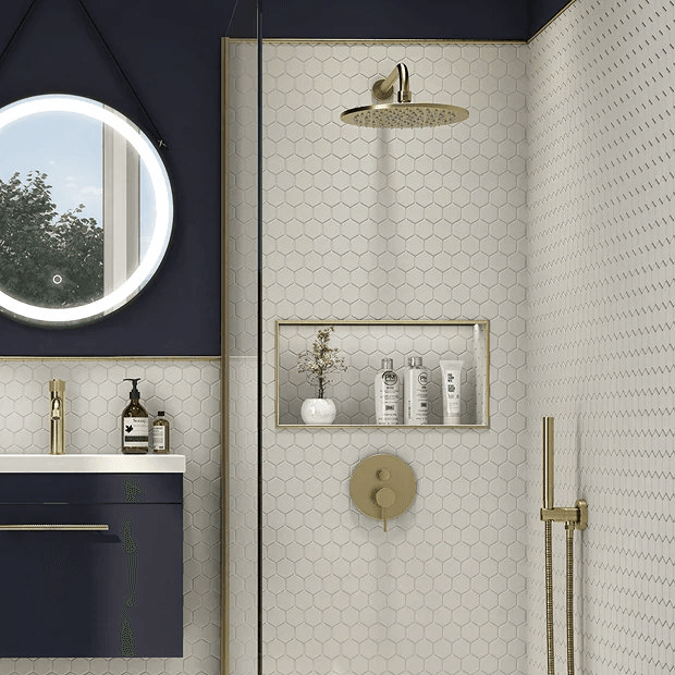 Brass shower fixings in blue and white bathroom