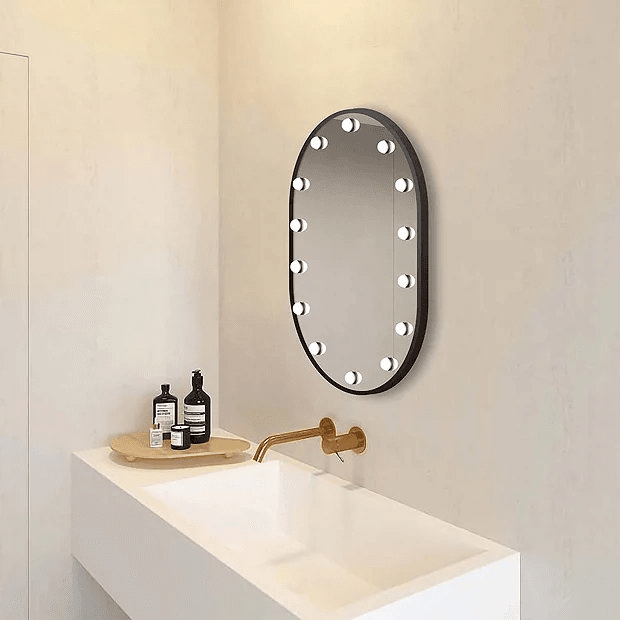 Black light up mirror with bulbs on cream wall