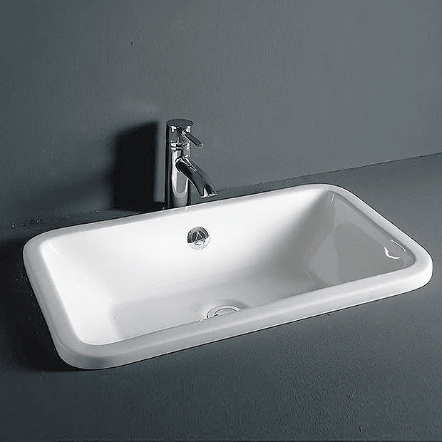 White inset basin on grey countertop with chrome tap