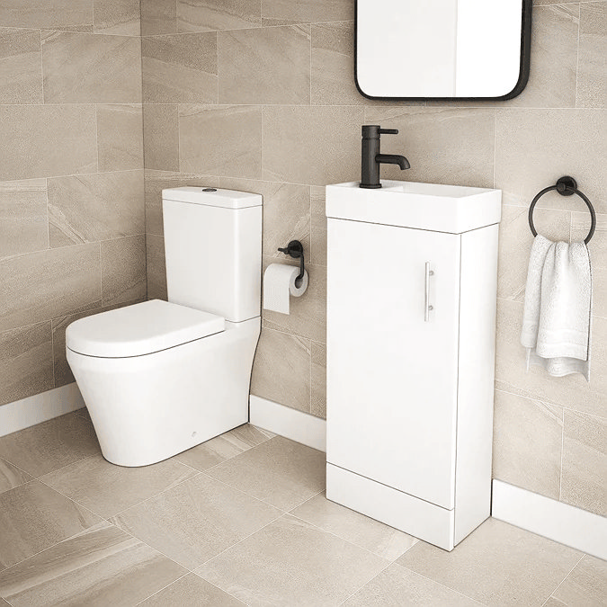 Modern toilet and space saving vanity unit on beige tiles