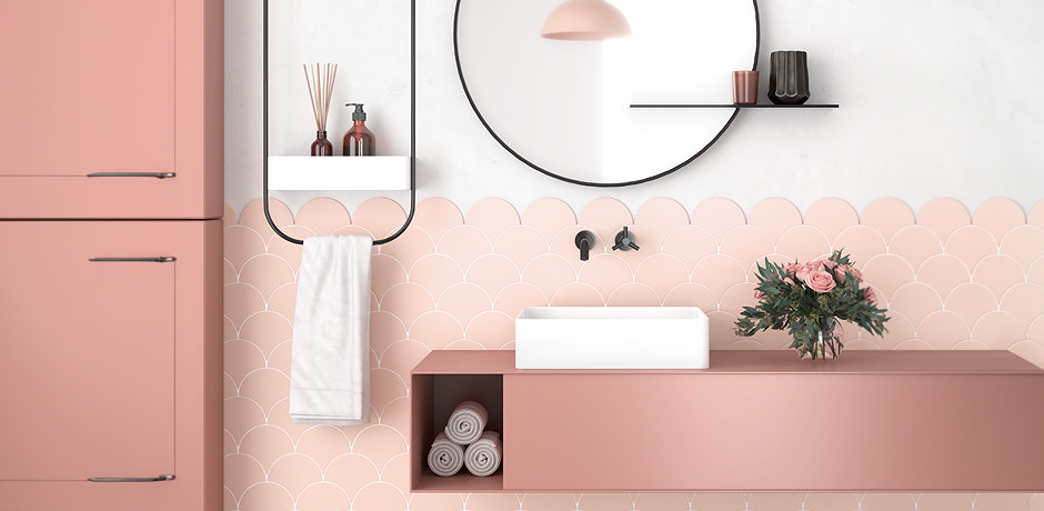 Pink fish scale wall tiles in bathroom with pink furniture