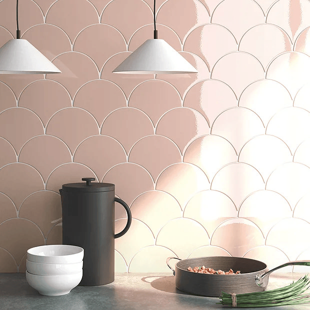 Pink fish scale wall ties in kitchen with hanging lights