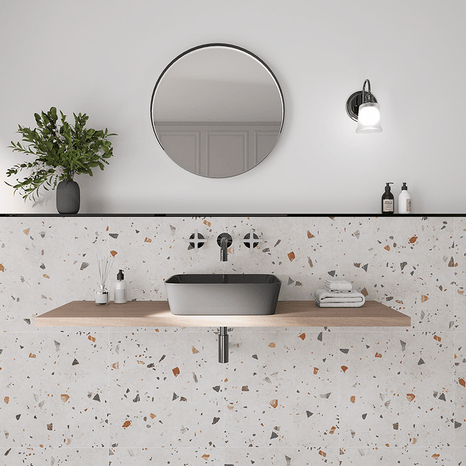 Terrazzo effect wall tiles with grey countertop basin