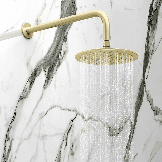 Brass shower on marble wall