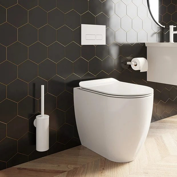 White toilet against black tiles
