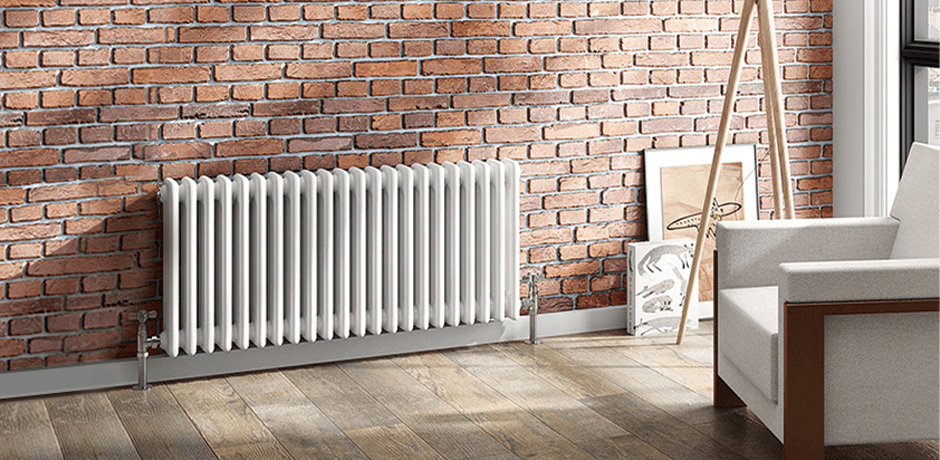 white column radiator exposed brick