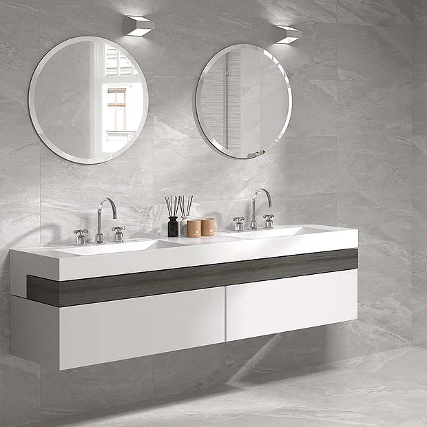 small angular wash basin against matt grey tiles 