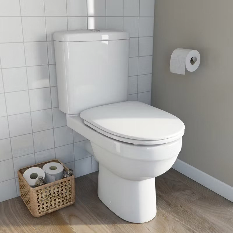 white toilet with bathroom accessories