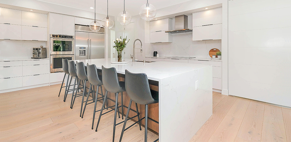 large kitchen island with black chairs