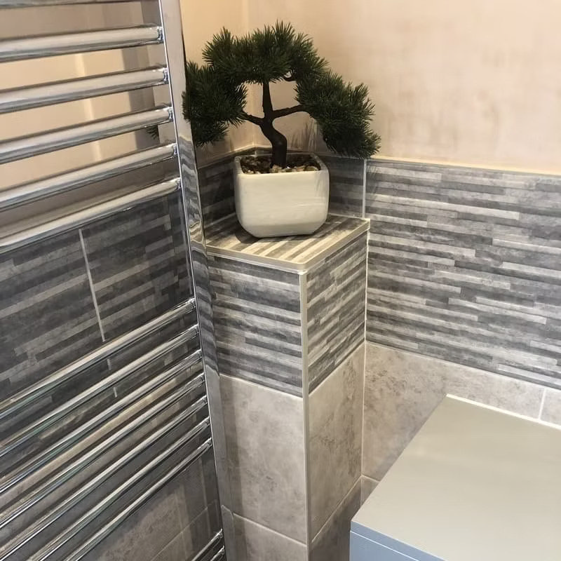 grey bathroom with chrome towel radiator