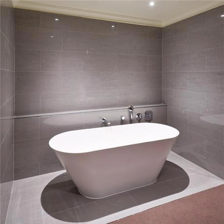 tall freestanding bath on light grey porcelain tile