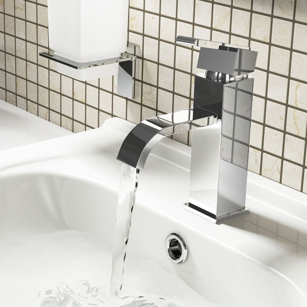 monochrome tap filling water in basin 