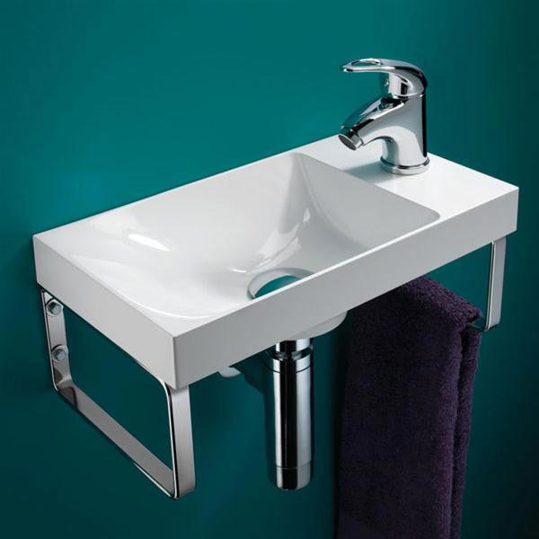 HIB Ocean Mineral Marble Washbasin - 8780 - Close up image of a modern cloakroom basin with towel rails against a turquoise wall.