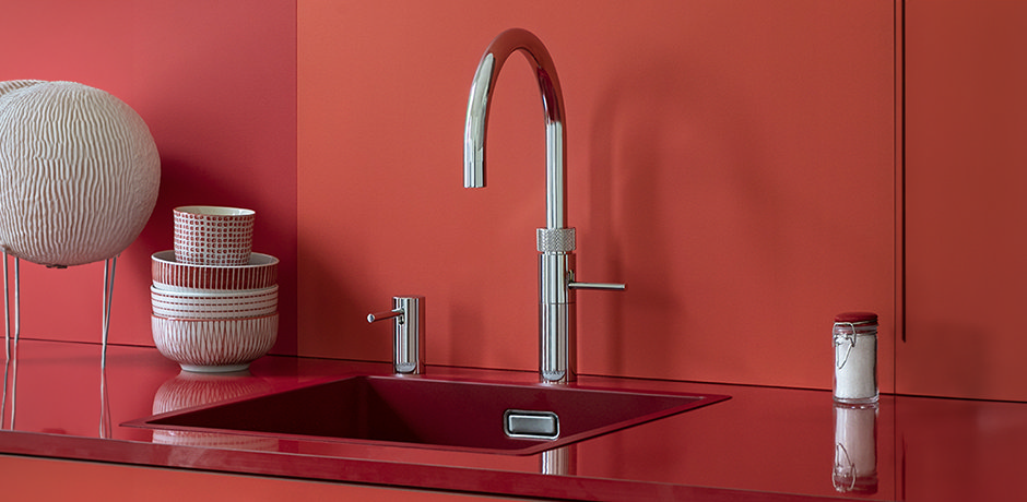 chrome quooker kitchen tap in red kitchen