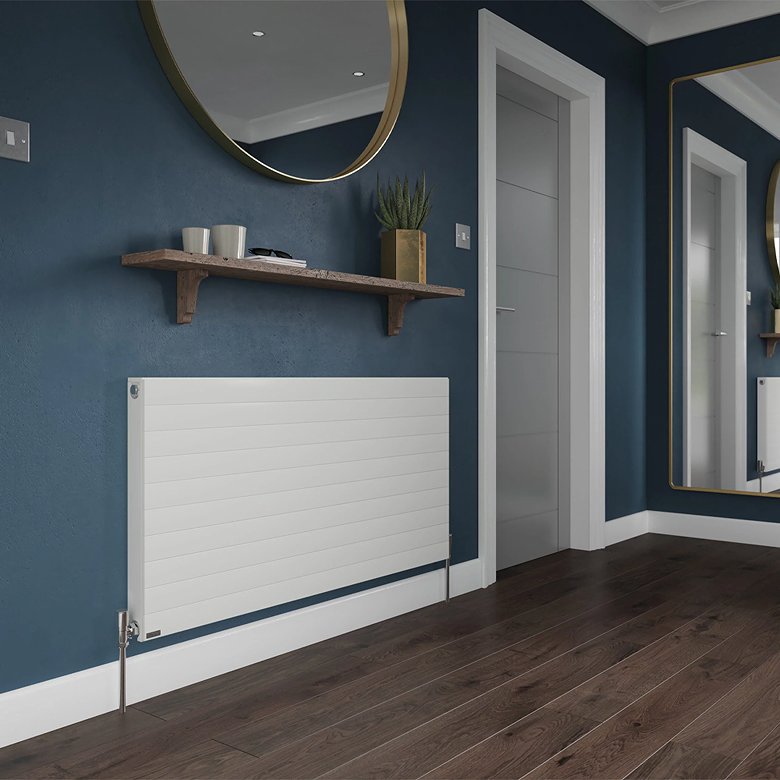 Modern white horizontal radiator mounted on a dark blue hallway wall beneath a wooden shelf