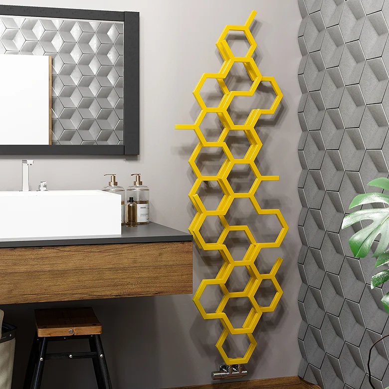 Yellow honeycomb designer radiator mounted beside a vanity unit in a modern bathroom