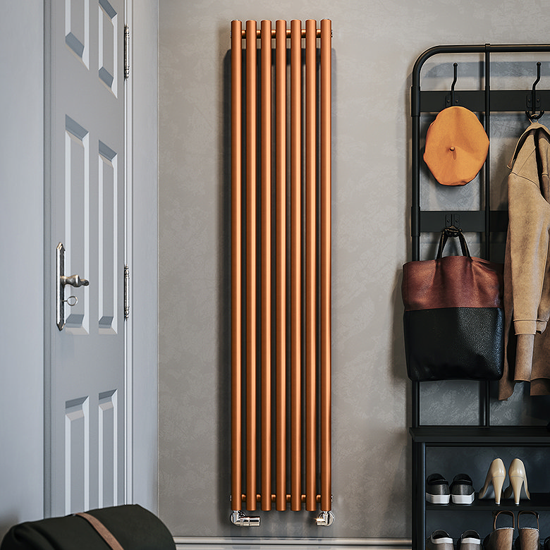 Tall copper vertical radiator mounted beside coat and shoe storage in a modern hallway