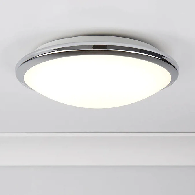 Modern round flush ceiling light with a chrome rim and frosted glass shade, providing soft and even illumination, suitable for contemporary bathrooms.