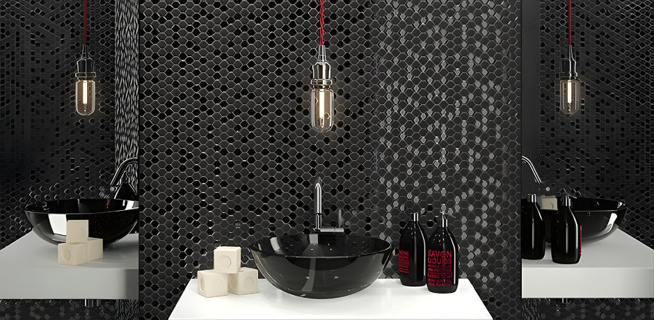 Modern bathroom with glossy black mosaic wall tiles, a black glass vessel sink, chrome tap and industrial pendant lighting above a white countertop.
