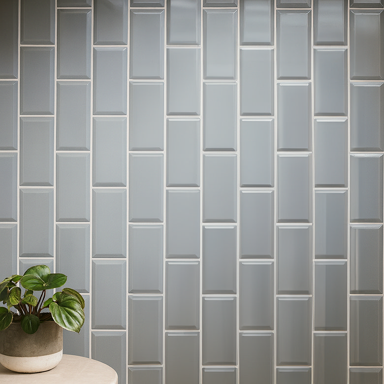 Step ladder tile pattern with grey rectangular tiles in modern bathroom wall design
